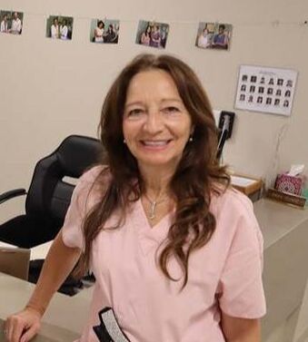 Olga Lafflitto Free Clinic of Simi Valley Dental Administrator stands at the nurses station with he big smile as always, ready to greet and help patients